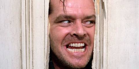 Jack Torrance sticks his face through a hole in the door in The Shining