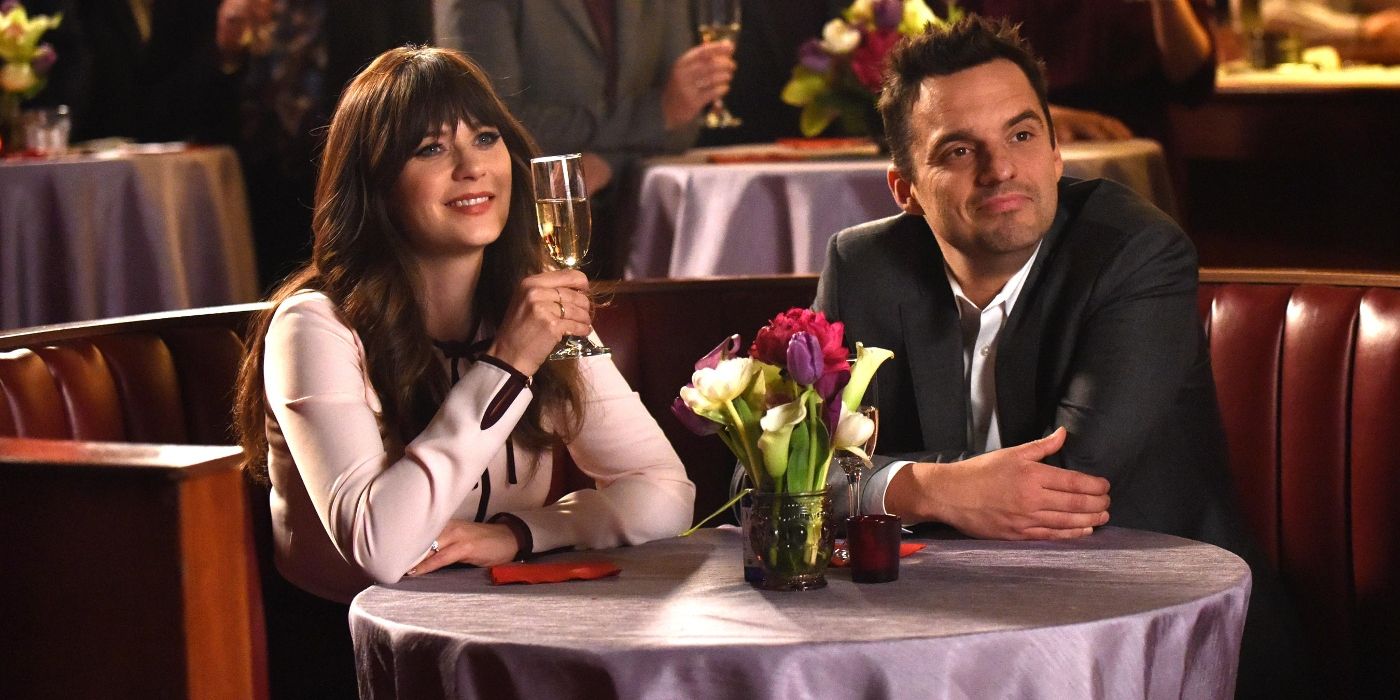 Jess and Nick celebrate their engagement at a table in a bar in New Girl