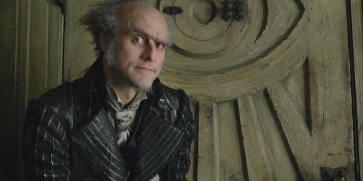 Count Olaf smiling while looking at the camera 