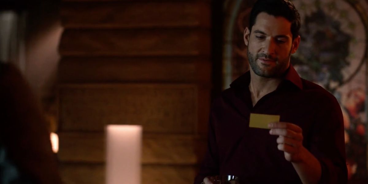 Lucifer looking at Kinley's business card in Lucifer