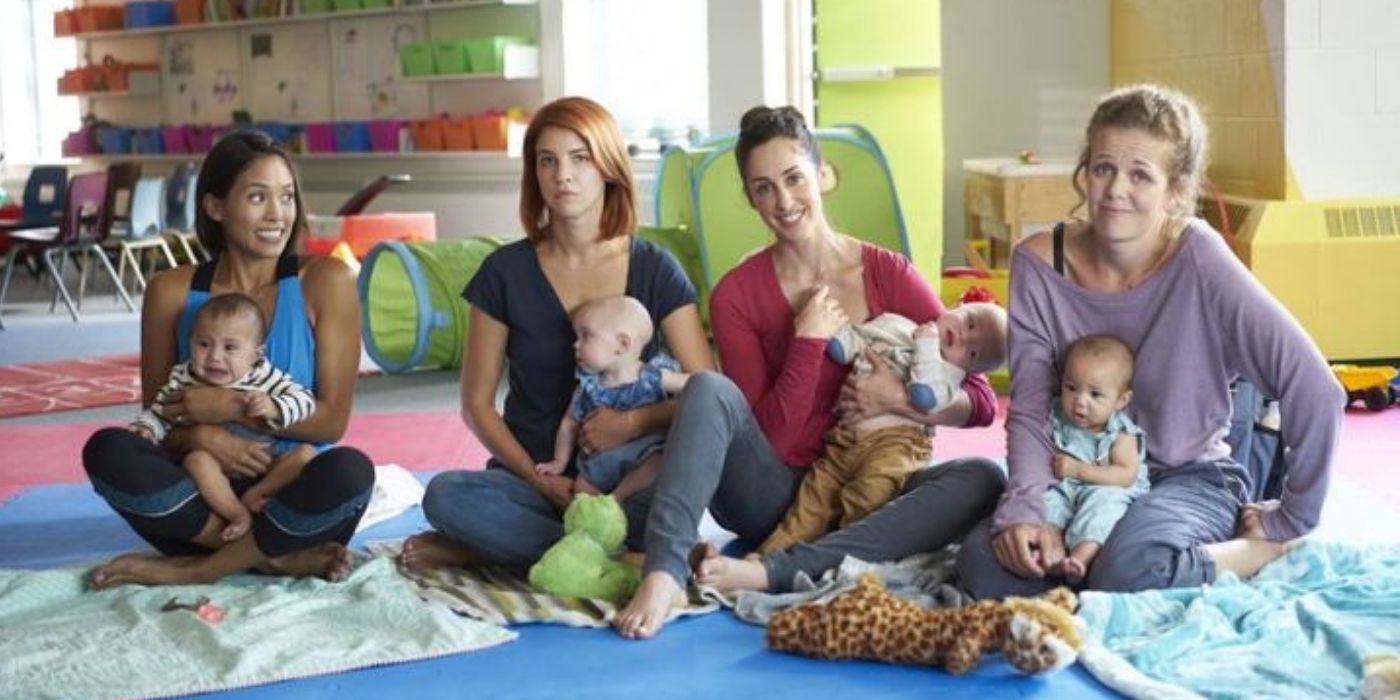 The moms sit cross-legged in the nursery in Workin' Moms