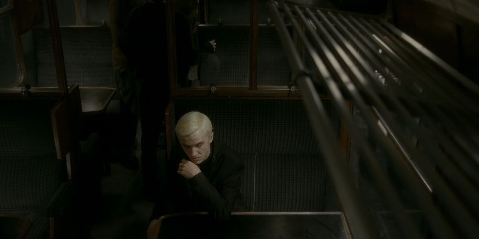 Draco Malfoy sits in a train
