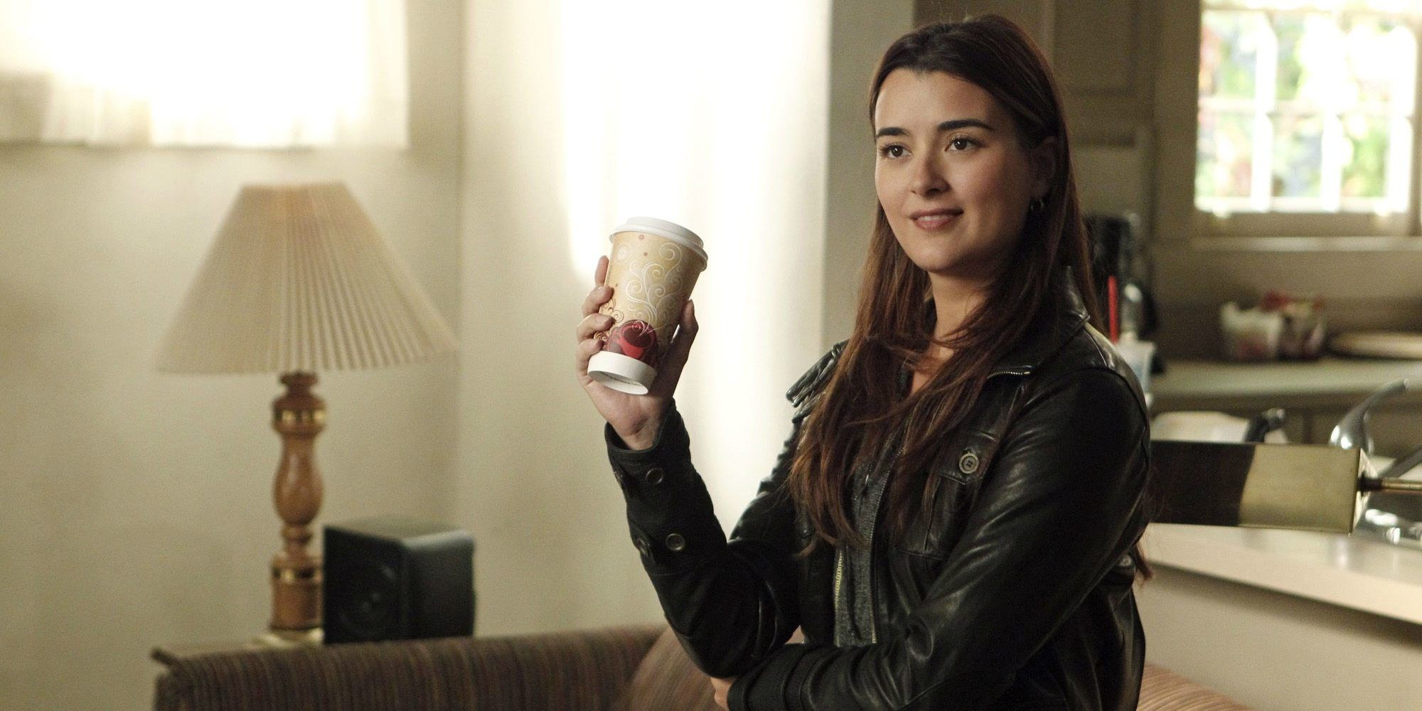 Ziva David grins while holding a coffee cup in NCIS