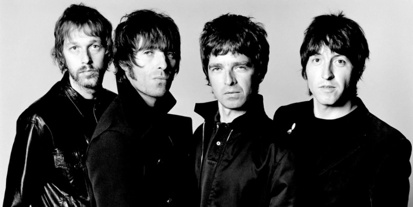 The members of Oasis pose for a photo