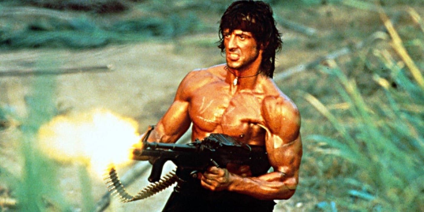 Sylvester Stallone holding a machine gun in Rambo First Blood Part II