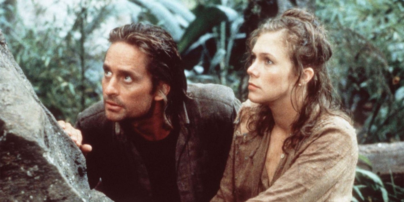 Jack and Joan hide behind a log in Romancing the Stone