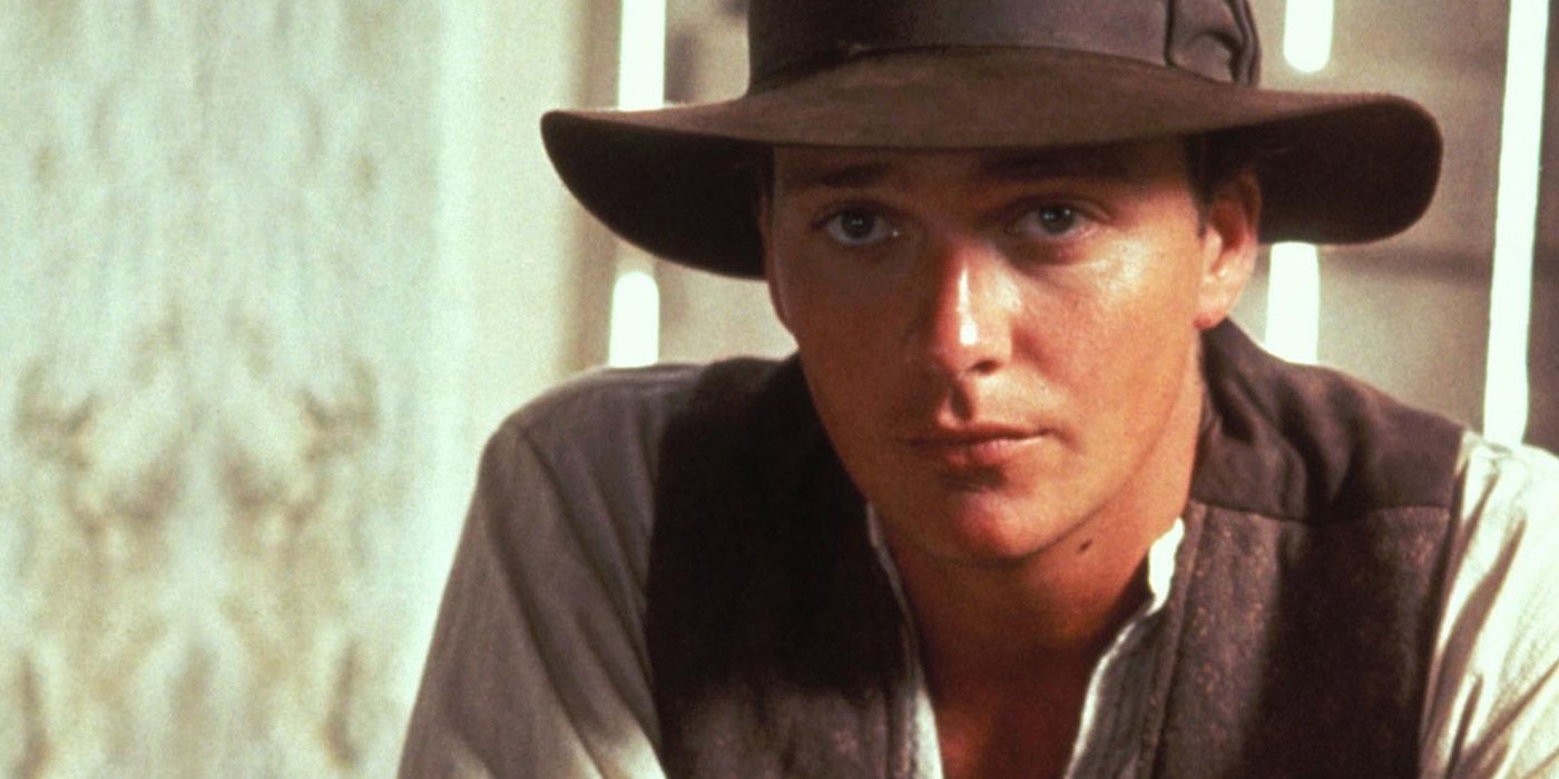 Sean Patrick Flanery as Young Indiana Jones looking serious in the fedora