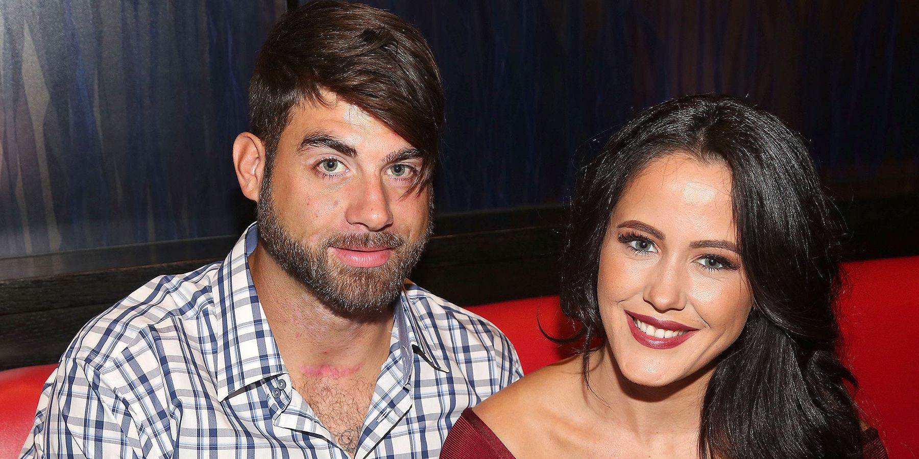 Teen Mom's Jenelle Evans and David Eason smiling on red couch