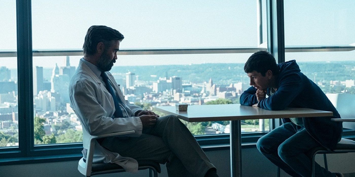 Steven (Colin Farrell) talking to Martin (Barry Keoghan) with a view of New York City through the window in The Killing Of A Sacred Deer.