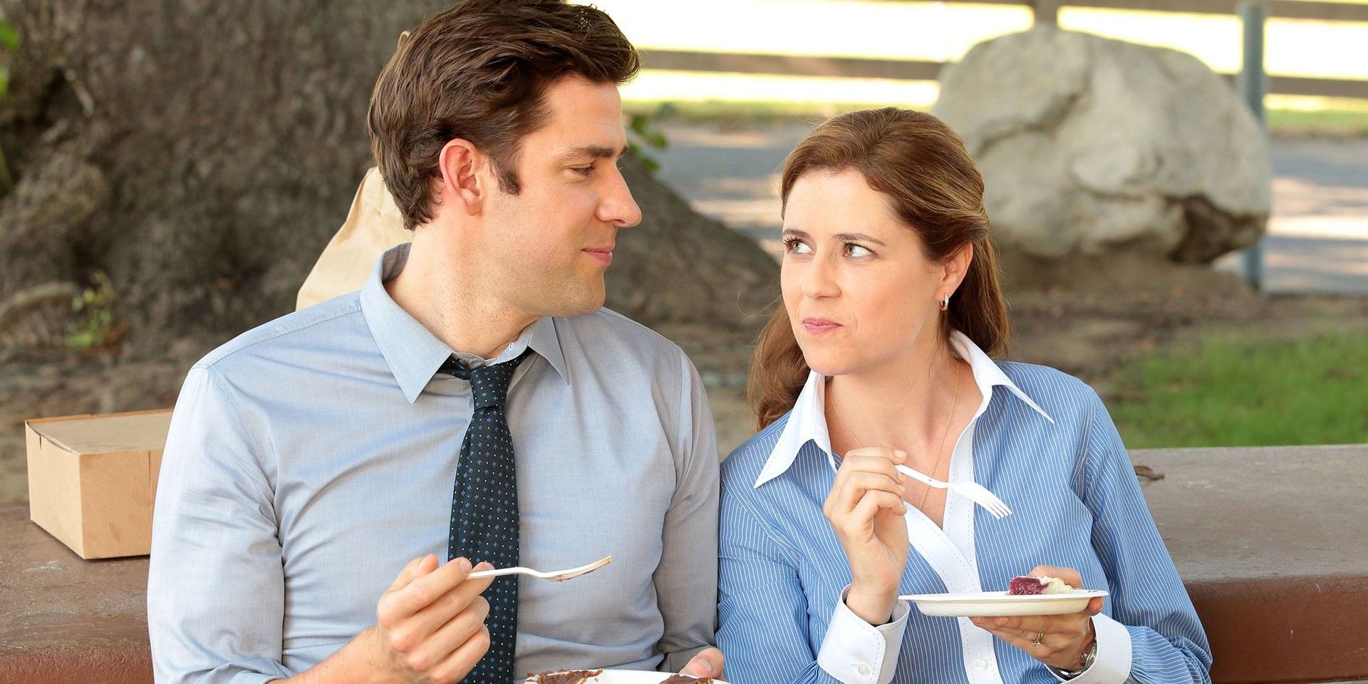 Jim and Pam looking at each other in The Office while eating from disposable plates