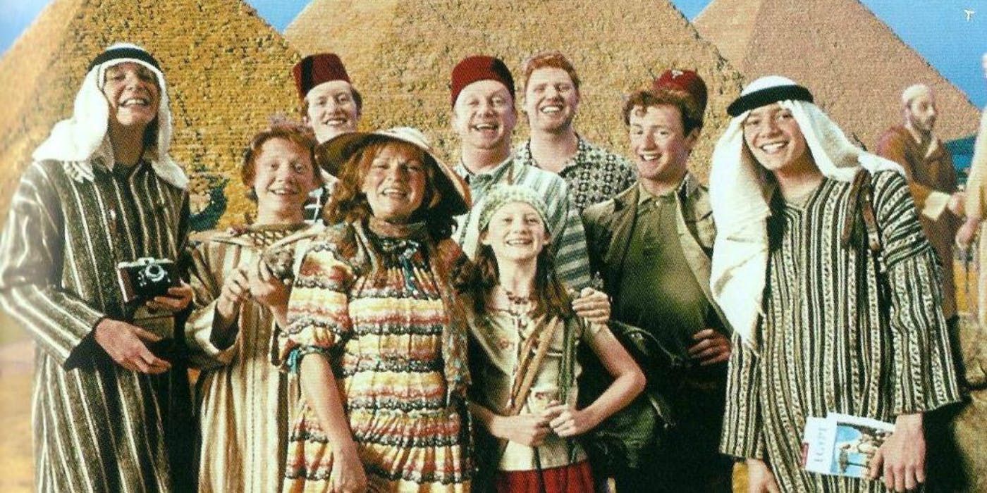 The Weasleys from Harry Potter standing in front of some pyramids dressed in Egyptian attire.