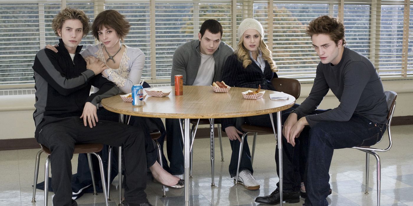 The Cullens sit together in the cafeteria in Twilight.