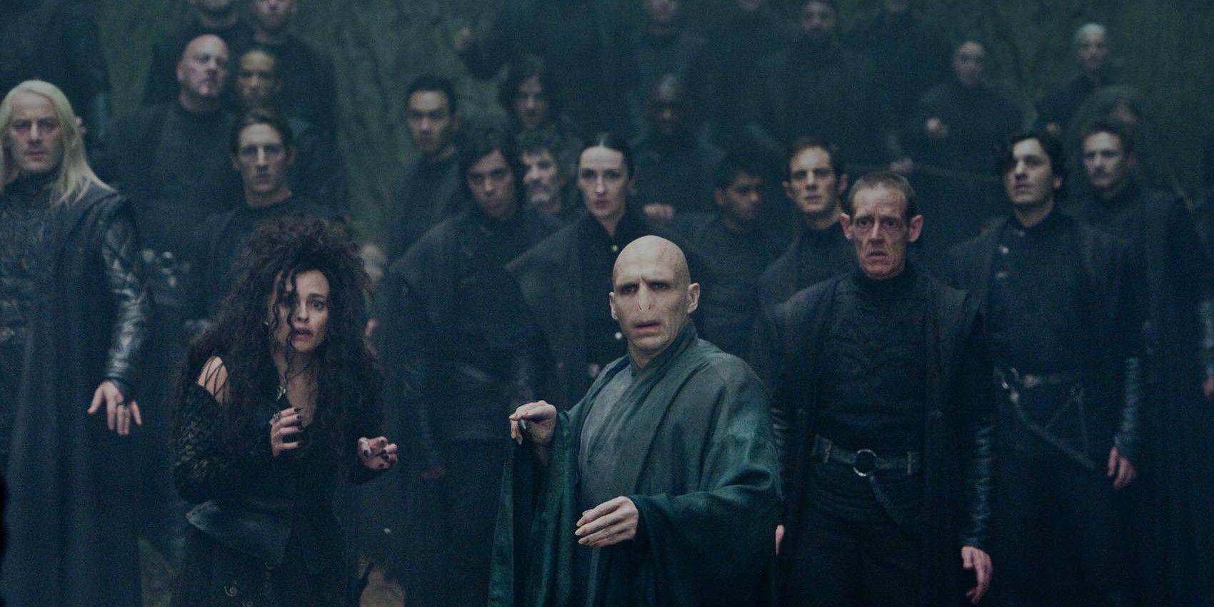 Voldemort and Bellatrix standing in front of an army of Death Eaters in The Deathly Hallows.