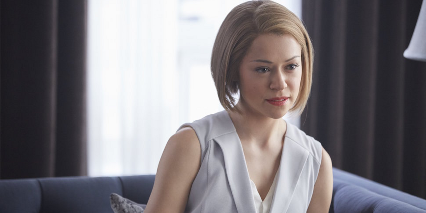 Rachel sitting on a couch looking smug in Orphan Black