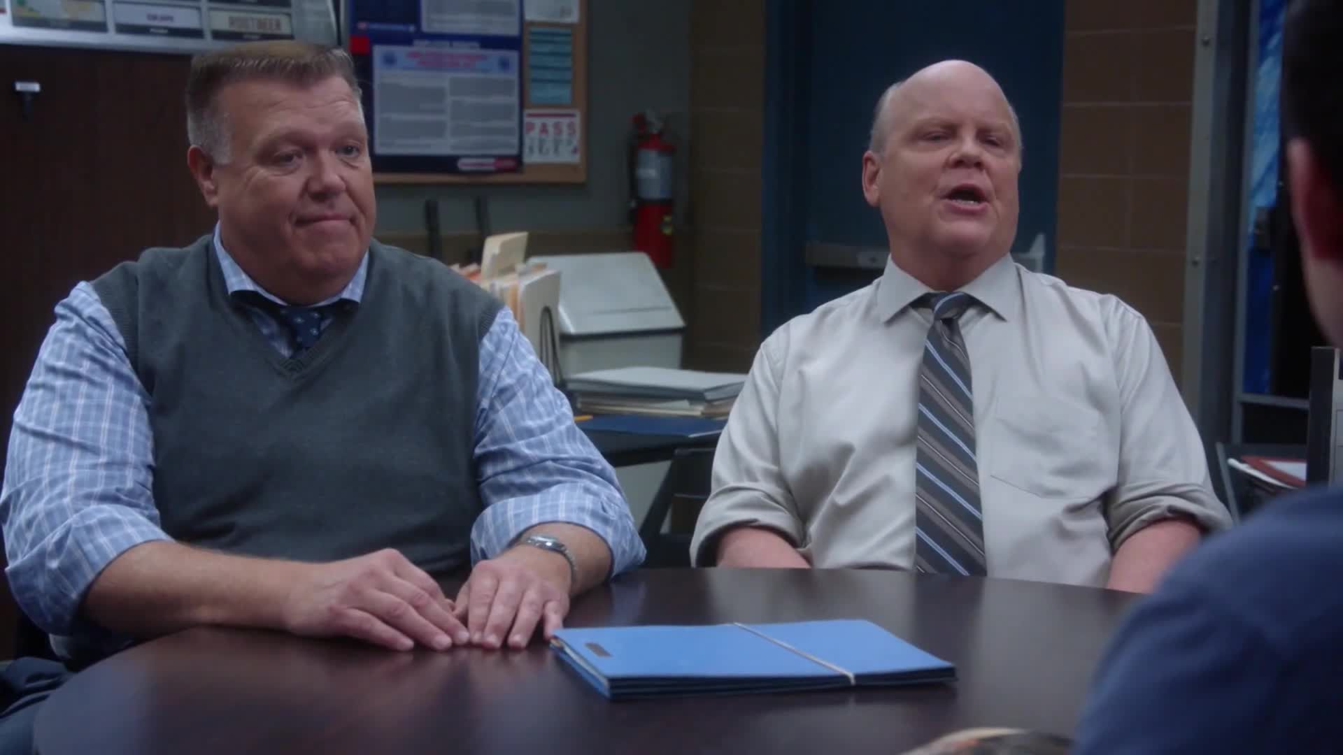 Hitchcock and Scully in the break room being questioned 