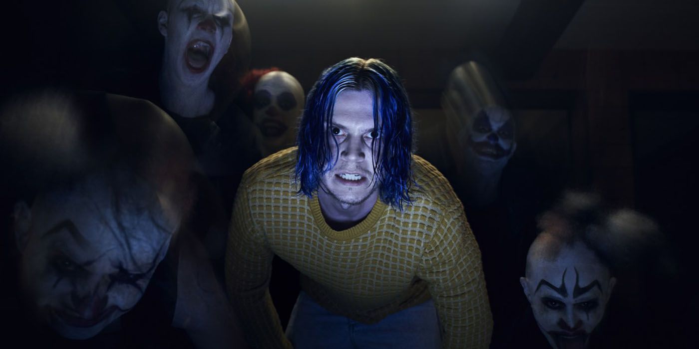 Kai Anderson grimaces with clowns around him in AHS: Cult