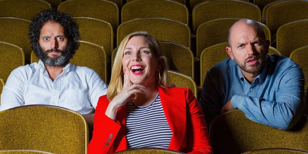Paul Scheer, June Diane Raphael, and Jason Mantzoukas of the How Did This Get Made podcast sitting in a theater