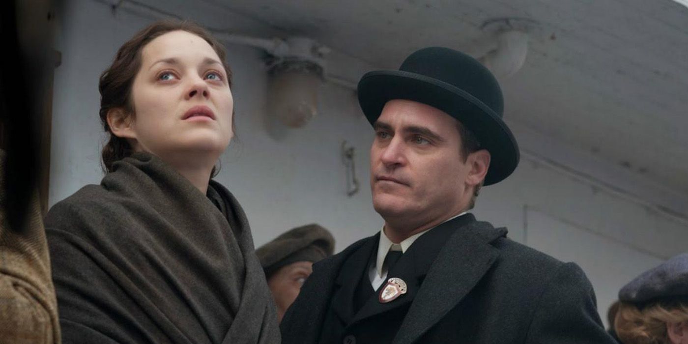 Marion Cotillard looking upwards while Joaquin Phoenix looks at her in The Immigrant