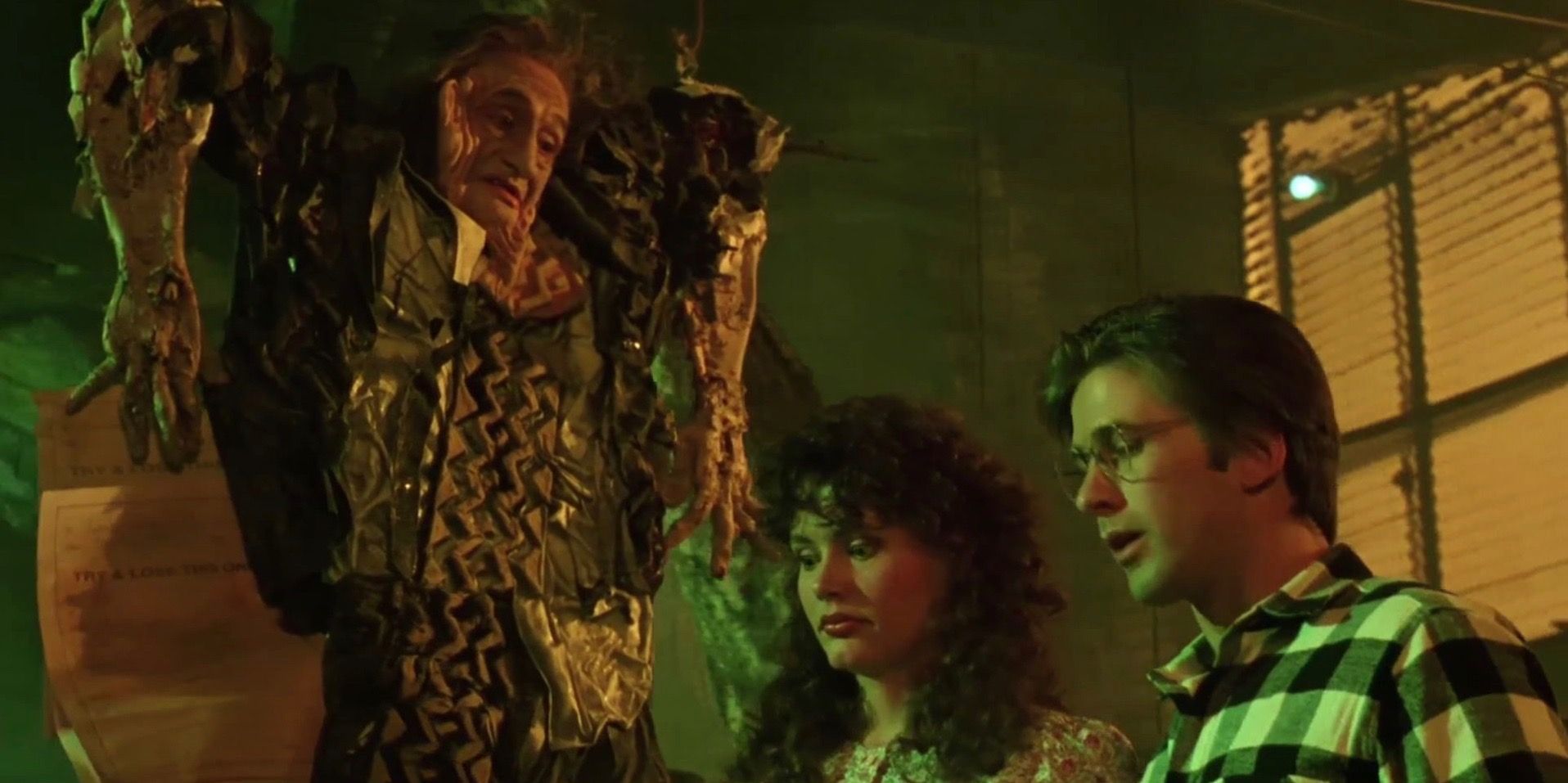 Adam and Barbara in Beetlejuice talking to the flat dead man.