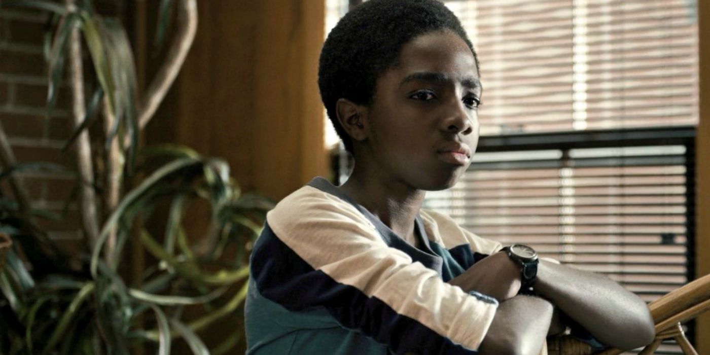 Caleb McLaughlin looks out a window in Stranger Things.