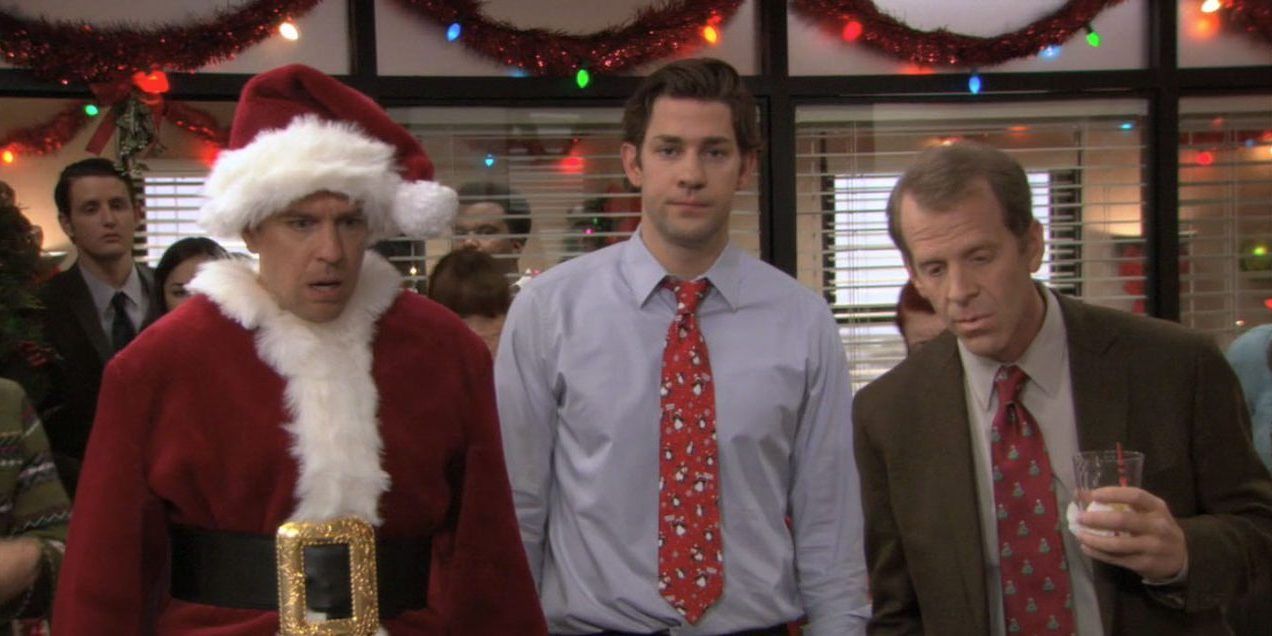 Andy dressed as Santa Claus with Jim and Toby on the Office