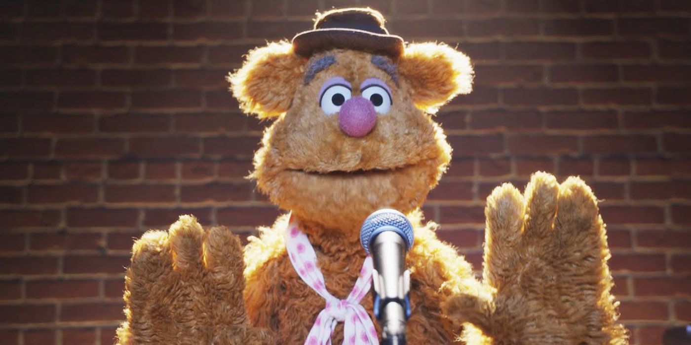 Fozzie Bear on the stage with a mic
