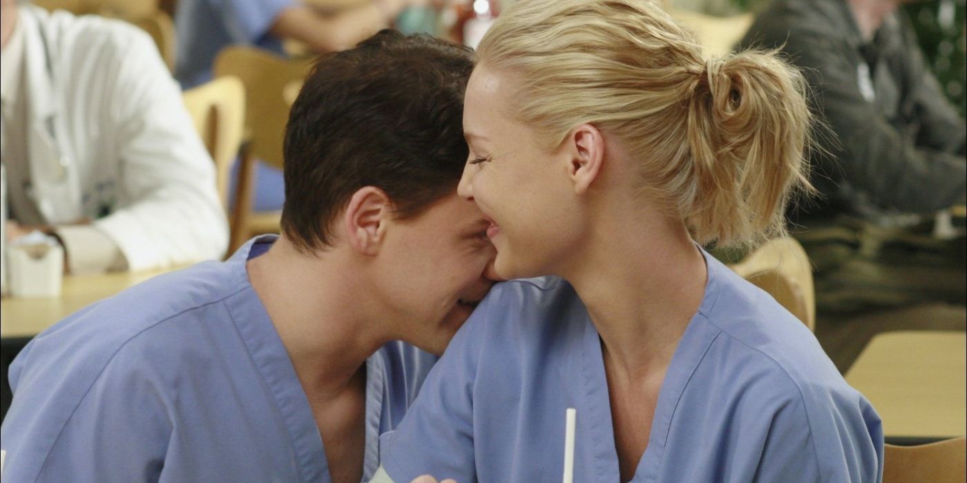 George laughing and hiding his face into Izzie's shoulder