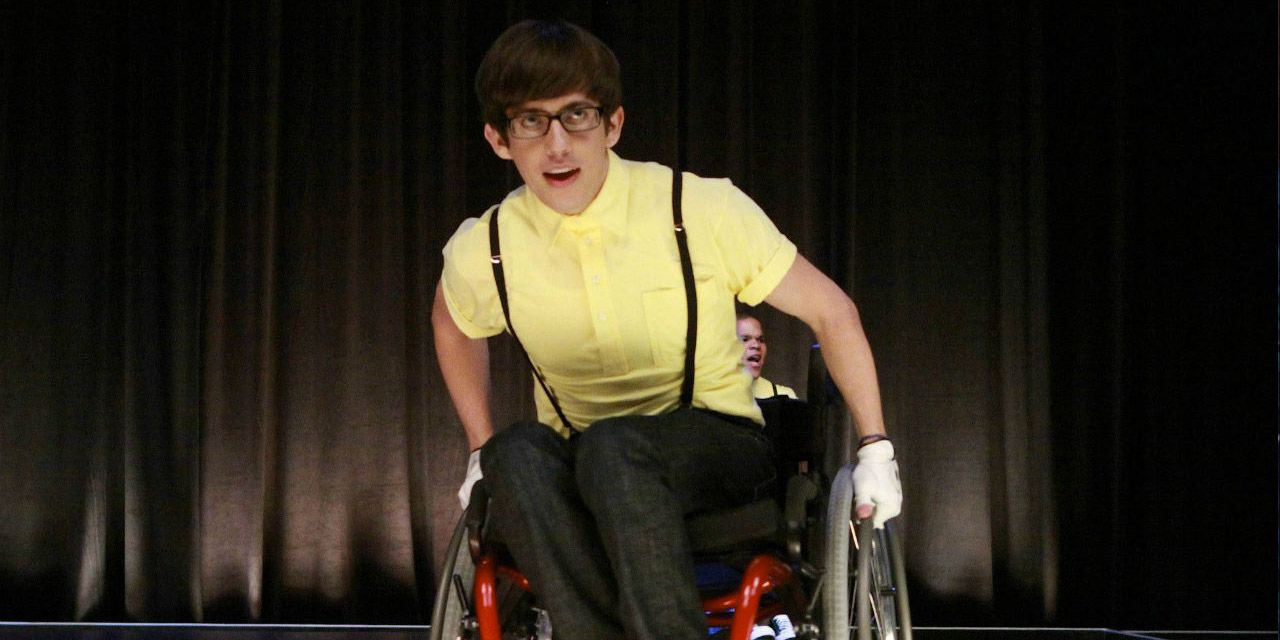 Artie performs on stage in his wheelchair in Glee