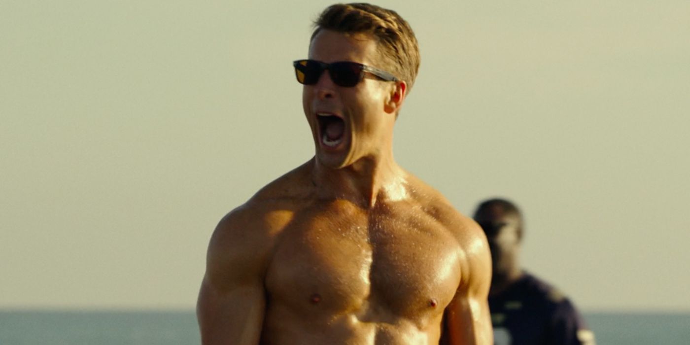 Hangman (Glen Powell) shirtless at the beach celebrating in Top Gun 2 Maverick