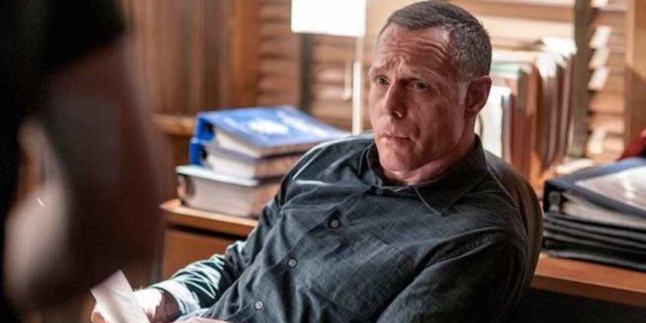 Hank Voight sits at his desk looking concerned at someone out of frame