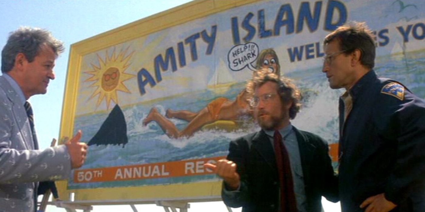 People talk by the Amity Island sign