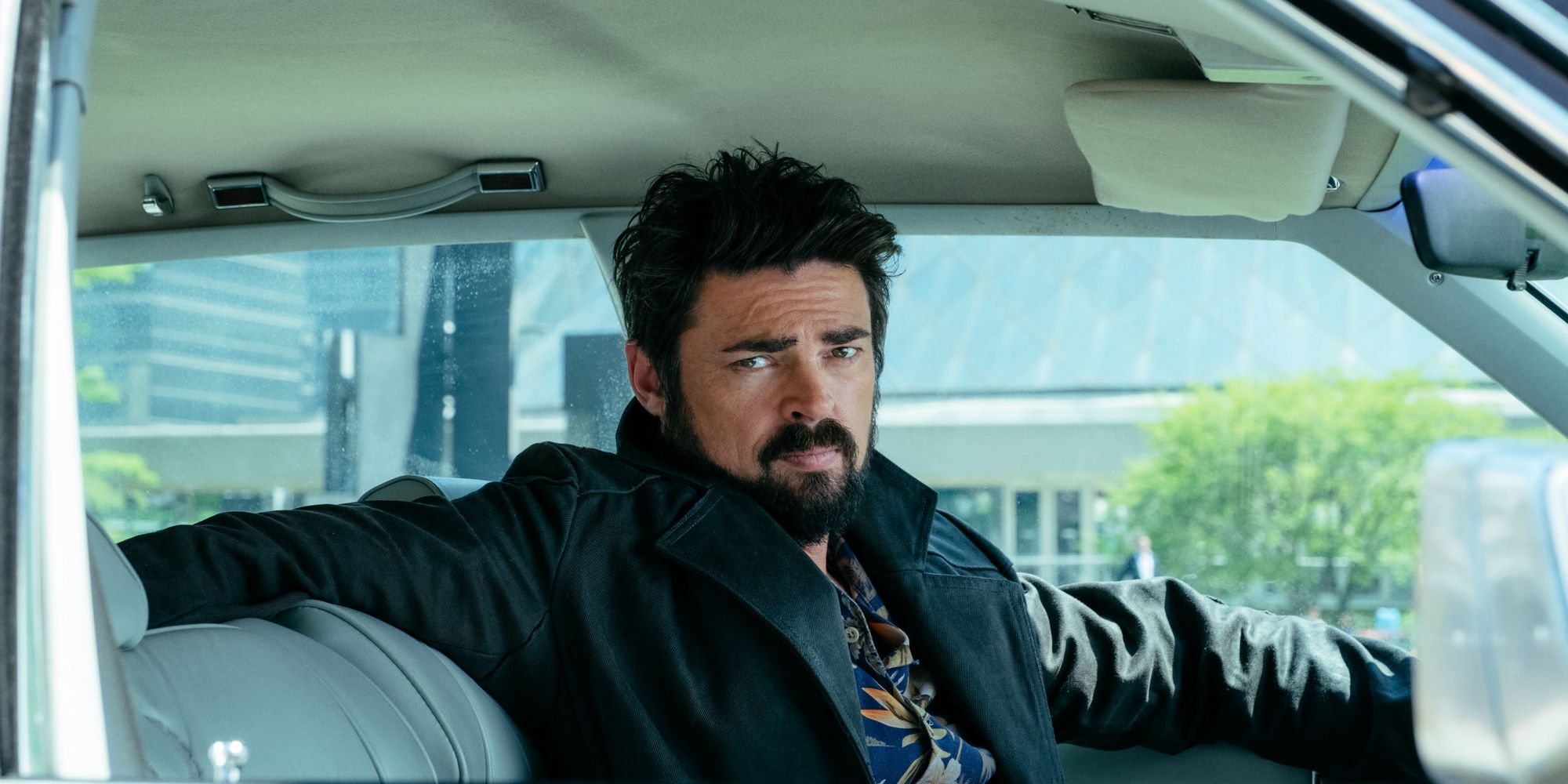 An image of Karl Urban sitting in a car in The Boys