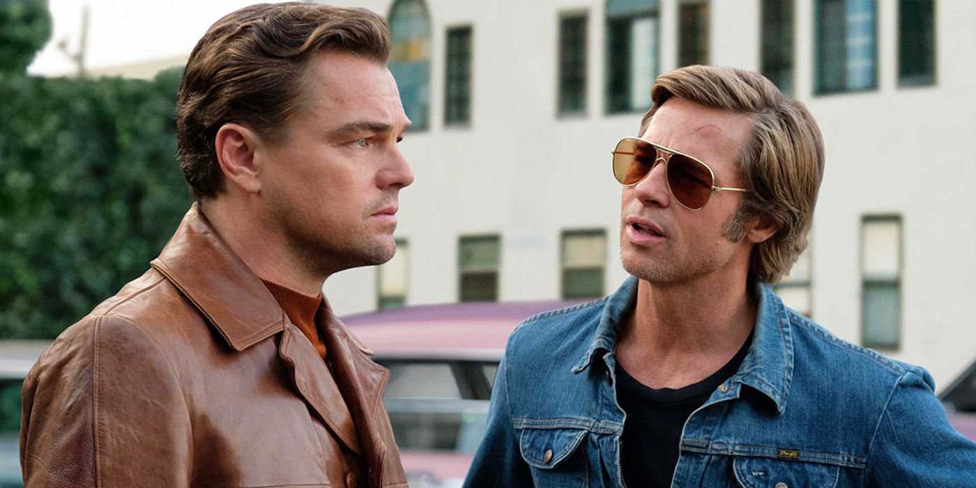 Leonardo DiCaprio and Brad Pitt standing in a parking lot in Once Upon a Time in Hollywood