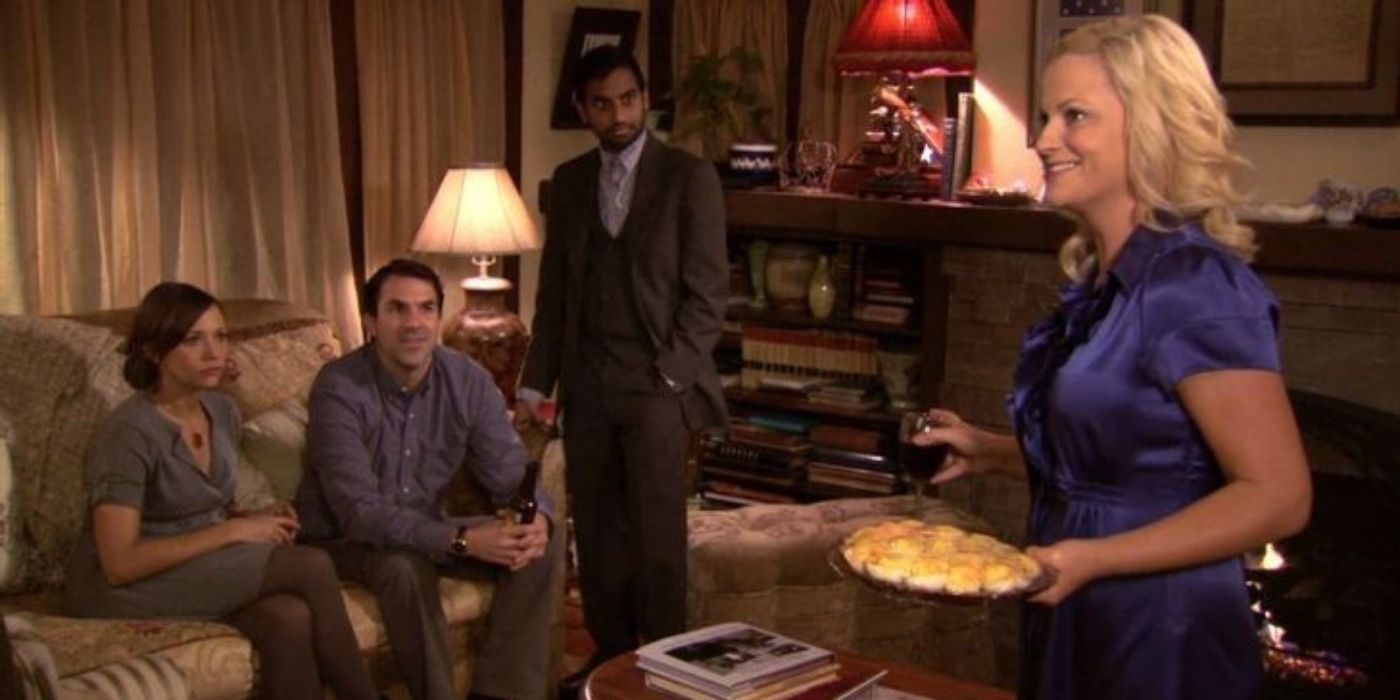 Leslie serving her guests food at a house party on Parks and Rec.
