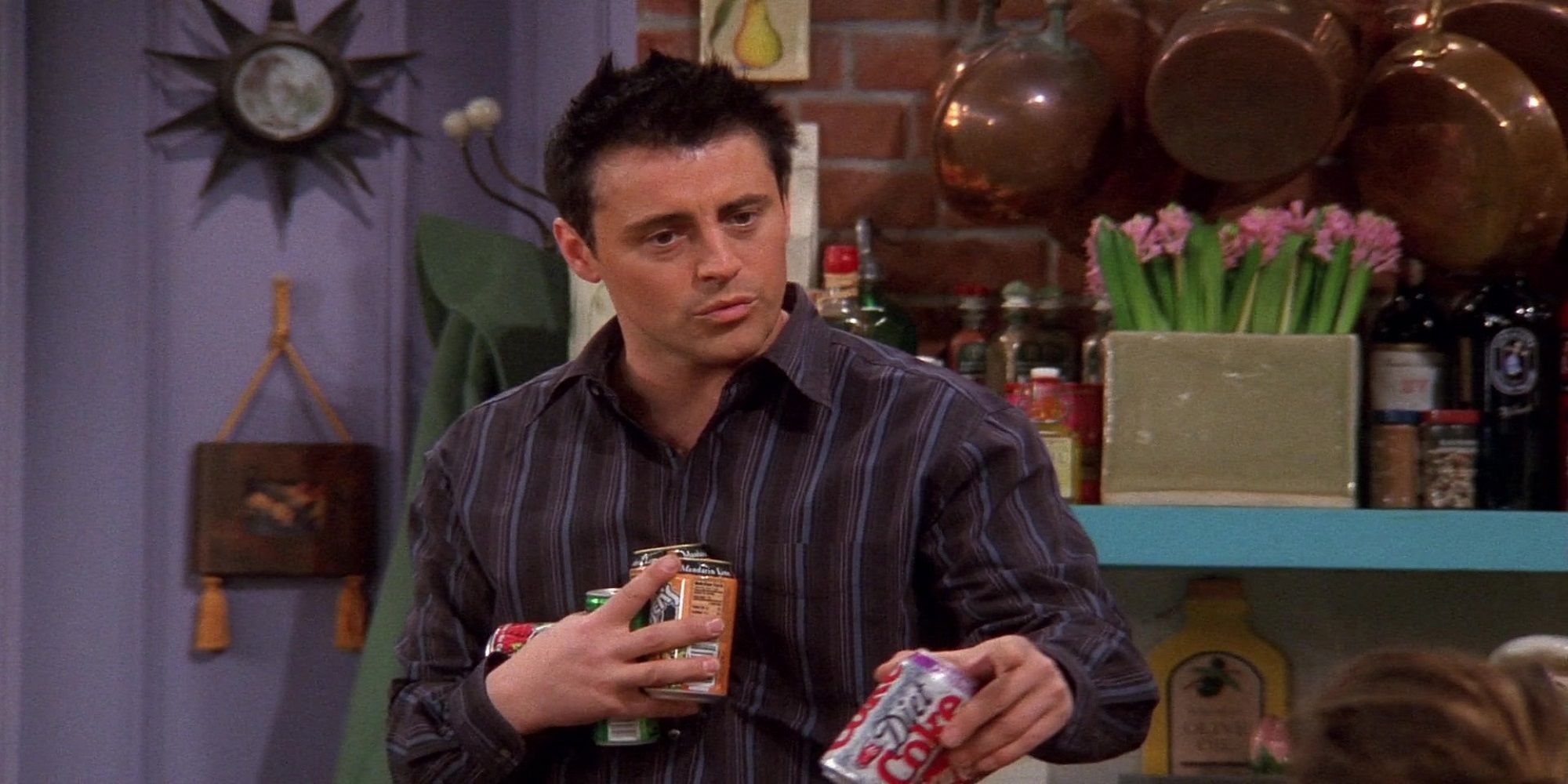 Joey holding a bunch of soda cans in Friends