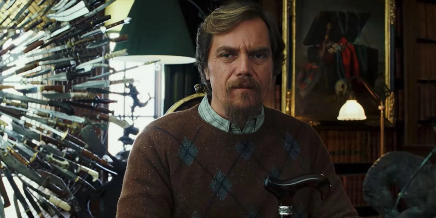 Michael Shannon sitting in front of the knives in Knives Out