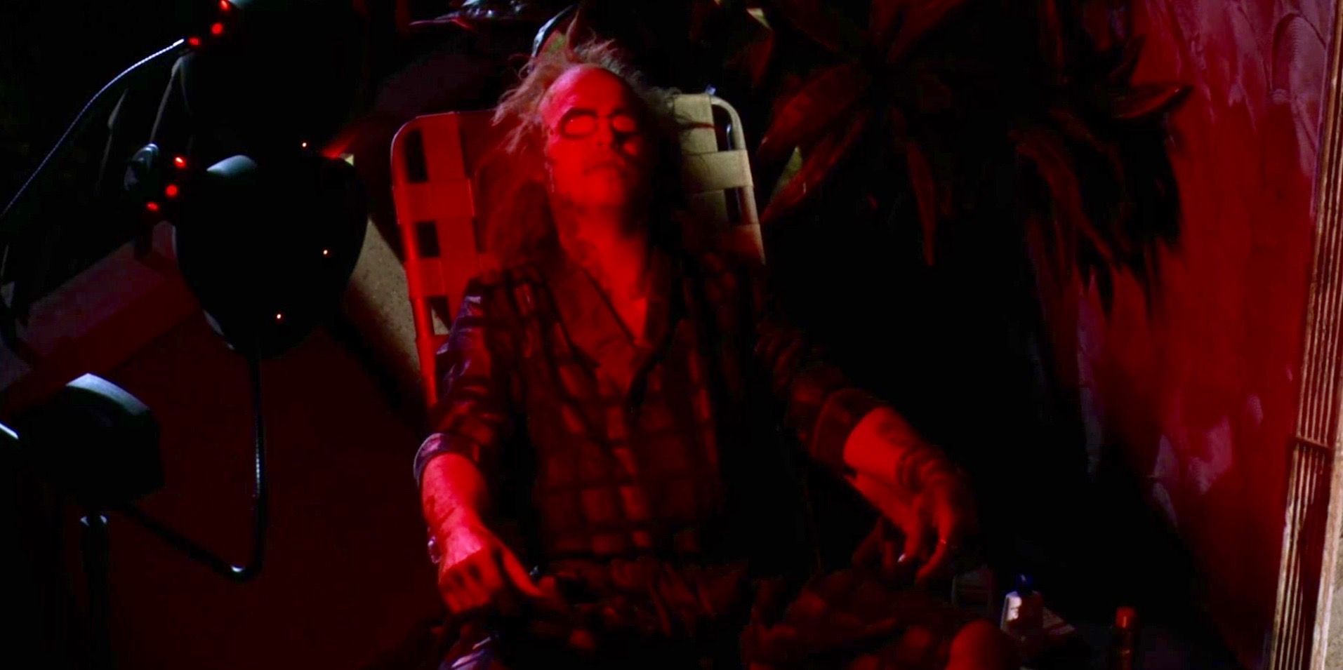 Michael Keaton sitting down as Beetlejuice