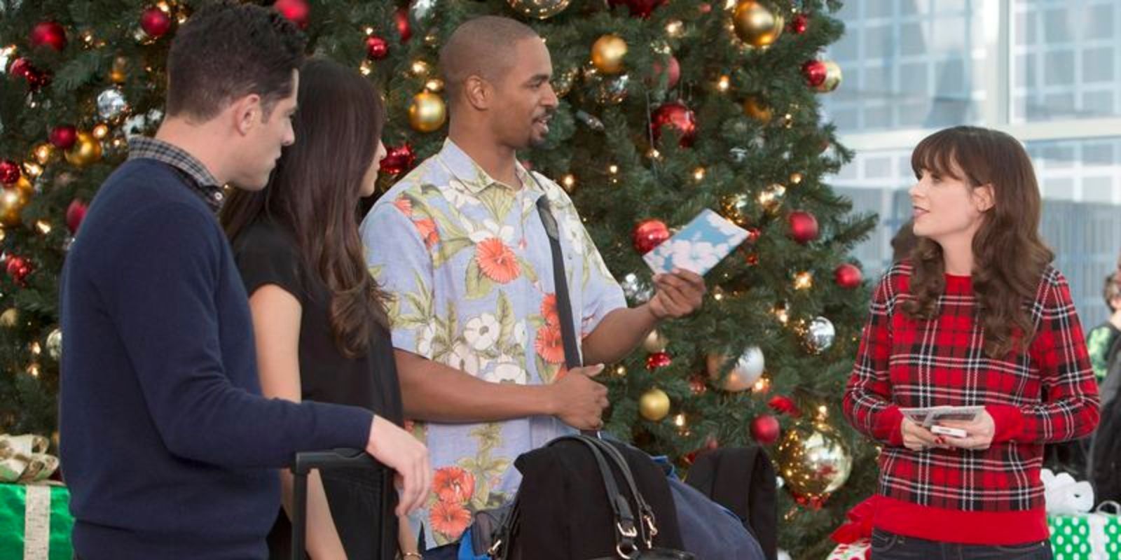 Schmidt, Cece, Coach, and Jess talk in front of a Christmas tree in the New Girls episode "LAXmas"