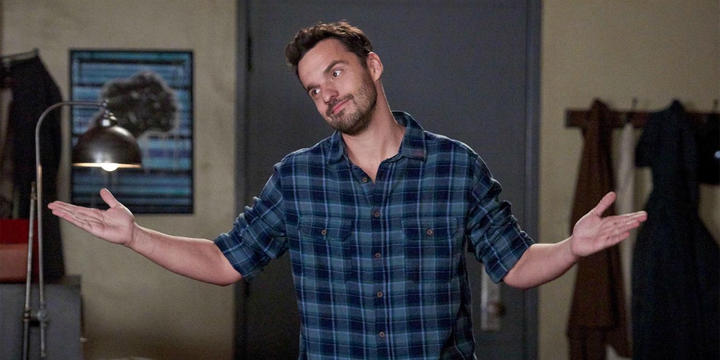 Nick with his arms raised and a surrendered expression in New Girl