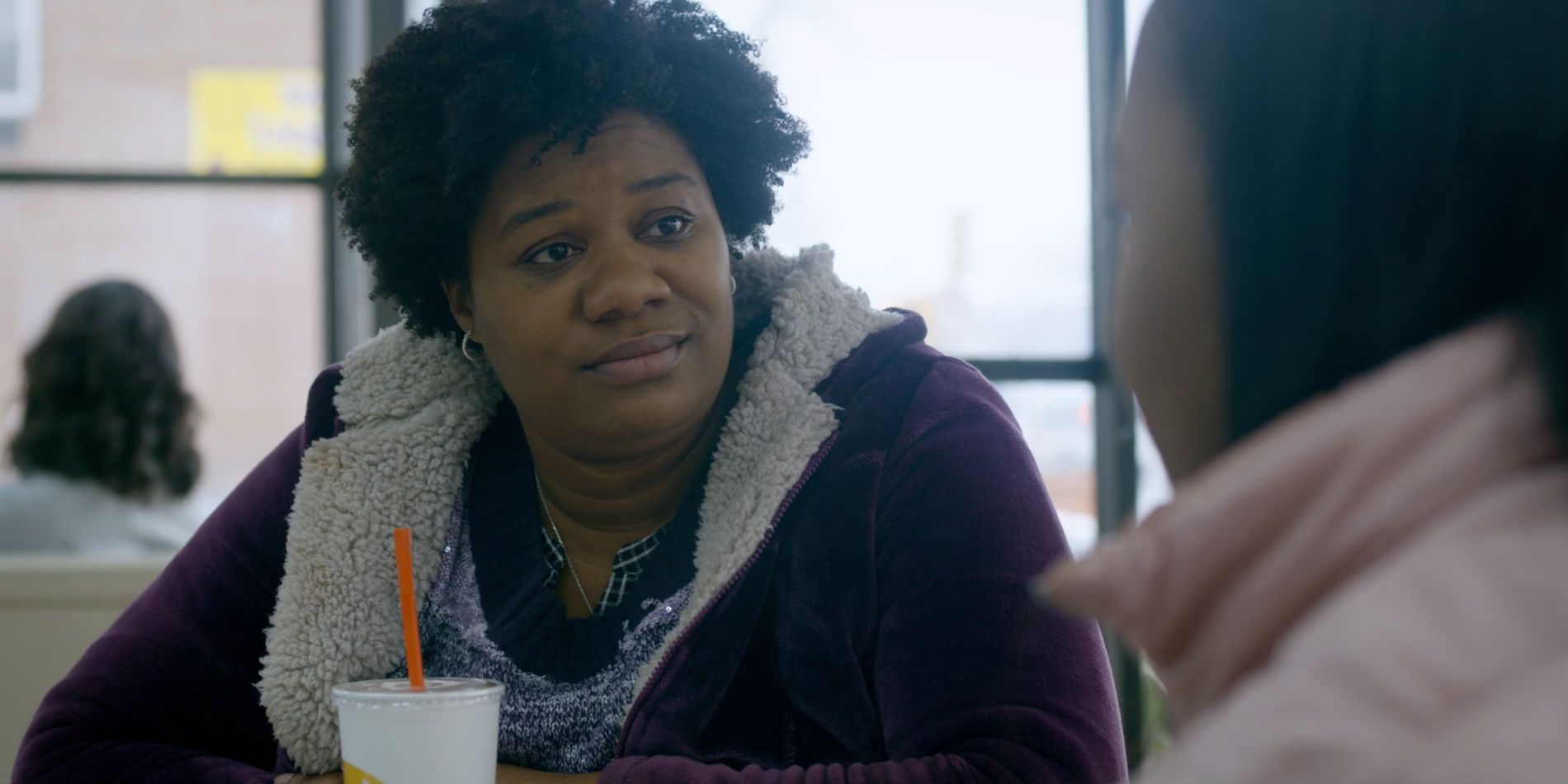 Black Cindy with a drink in Orange is the New Black.