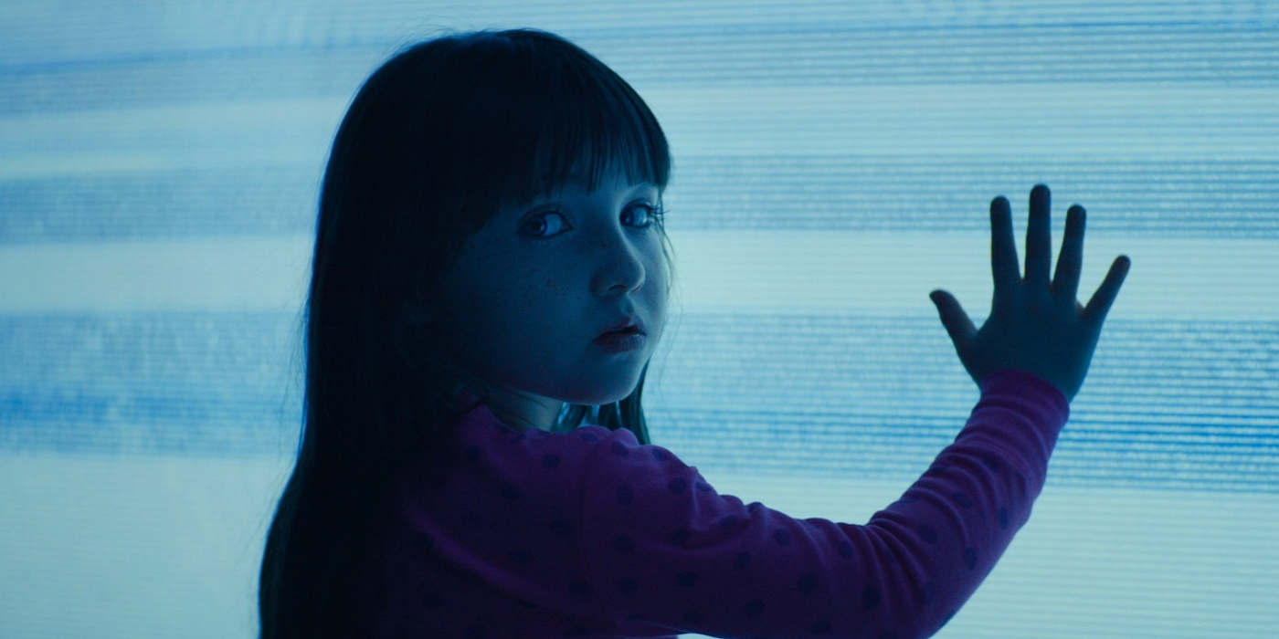 The child holding their hand up in front of a blue screen in Poltergeist