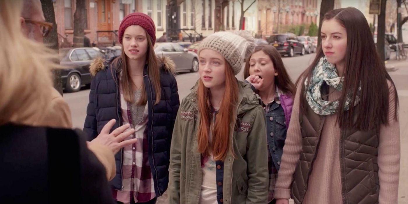 Sadie Sink standing with a group of girls in Unbreakable Kimmy Schmidt