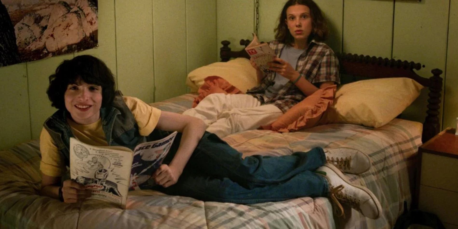 Stranger Things' Mike And Eleven lounging on a bed