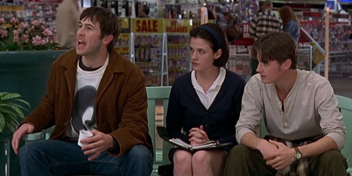 T.S. and Brodie sitting on a bench in the mall in Mallrats
