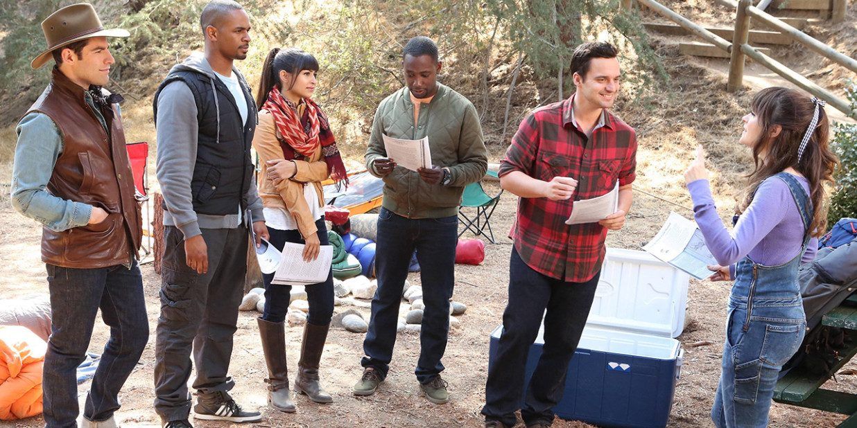 New Girl's main characters stand outside with their camping gear and foraging instructions in the episode Thanksgiving III
