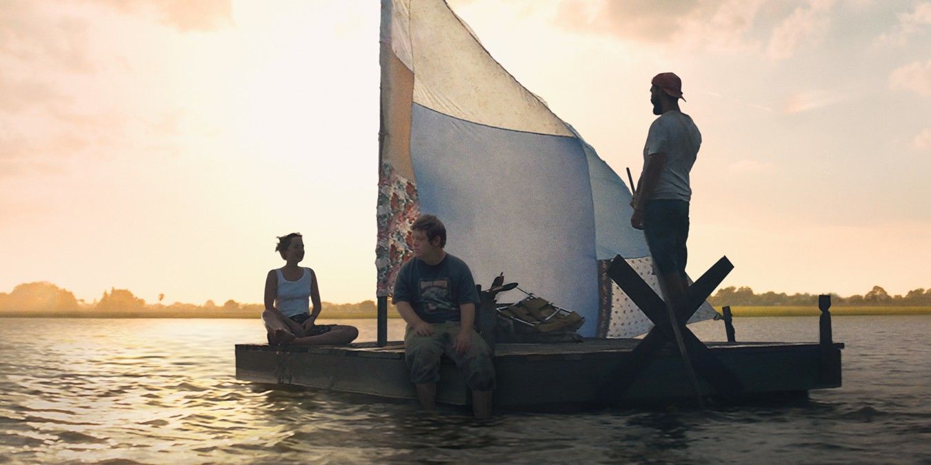 Characters sail on a boat in The Peanut Butter Falcon