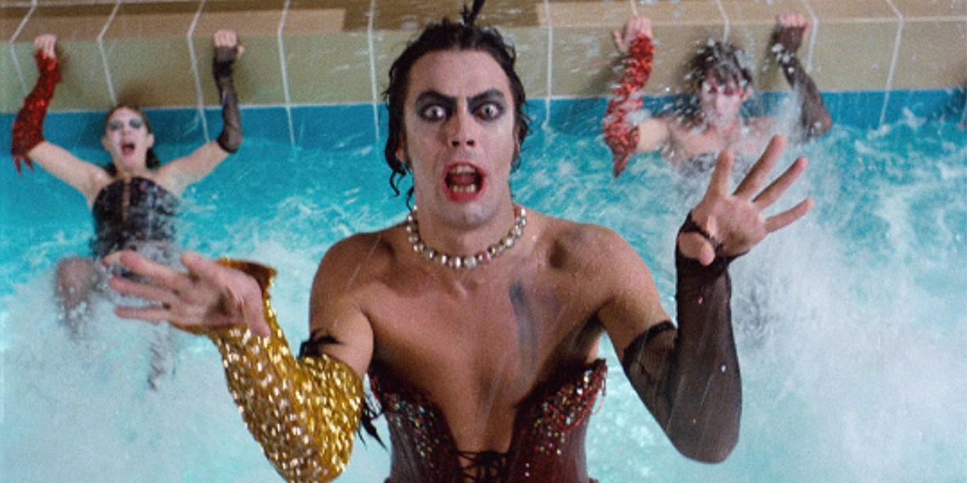 Tim Curry as Dr. Frank-N-Furter in a pool wearing a maroon corset in Rocky Horror Picture Show