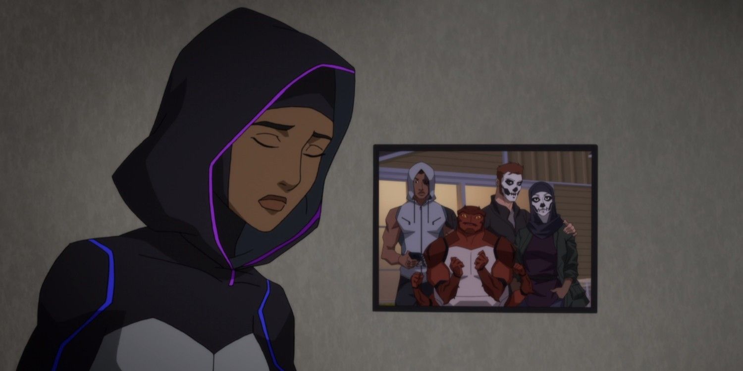 Halo looking sad while standing beside a picture of her friends in Young Justice