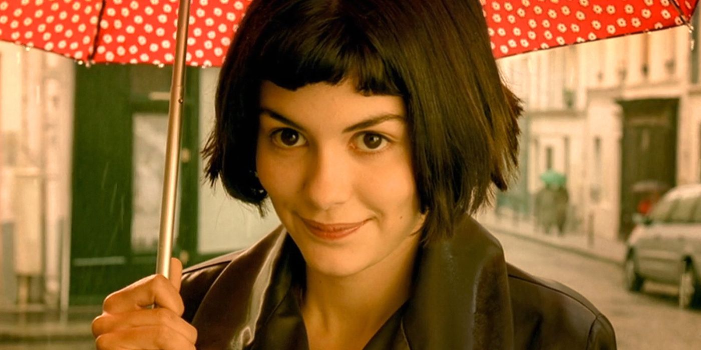 Amelie holding an umbrella and smiling.
