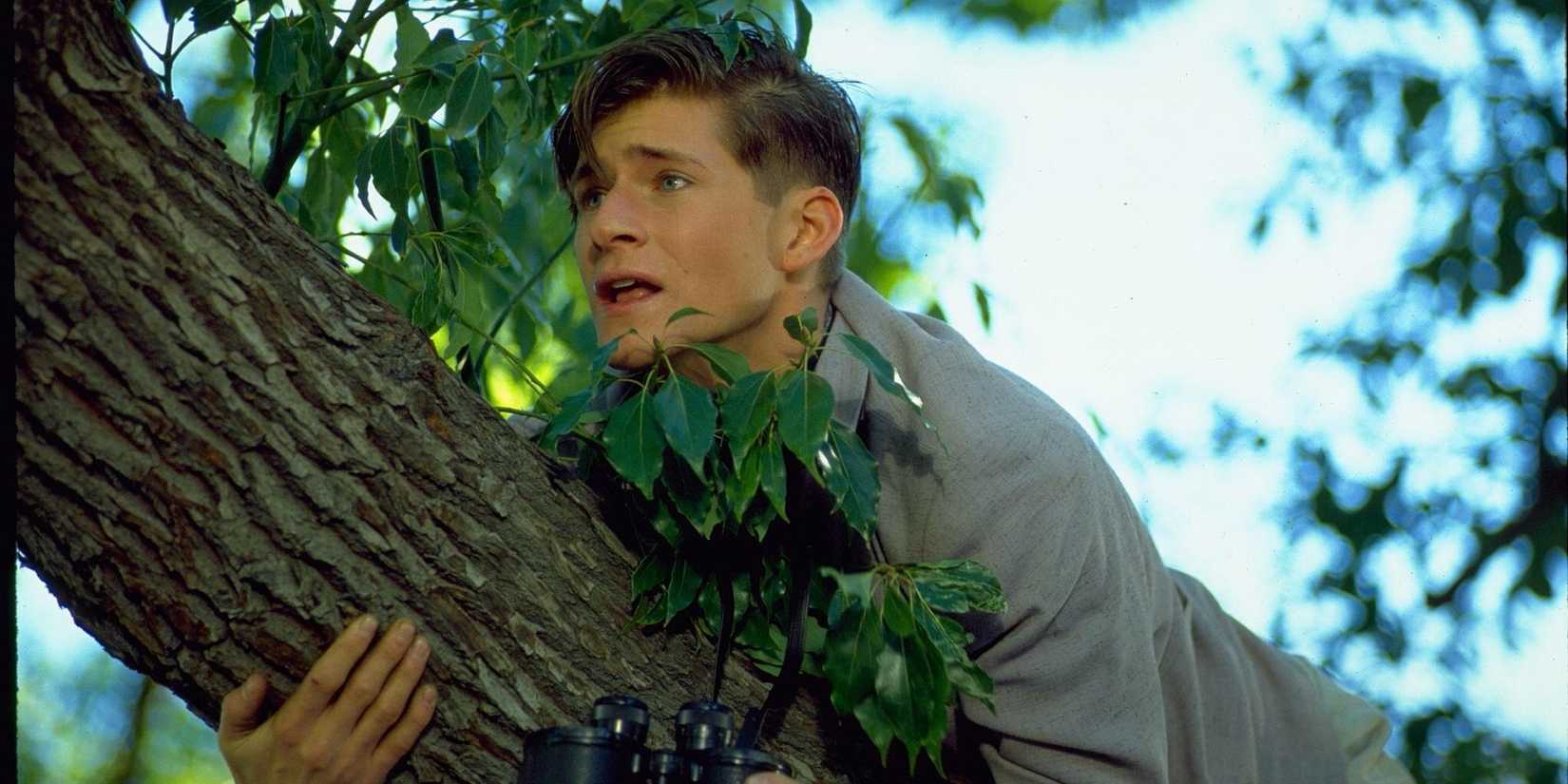 Crispin Glover as George McFly climbing a tree in Back to the Future.
